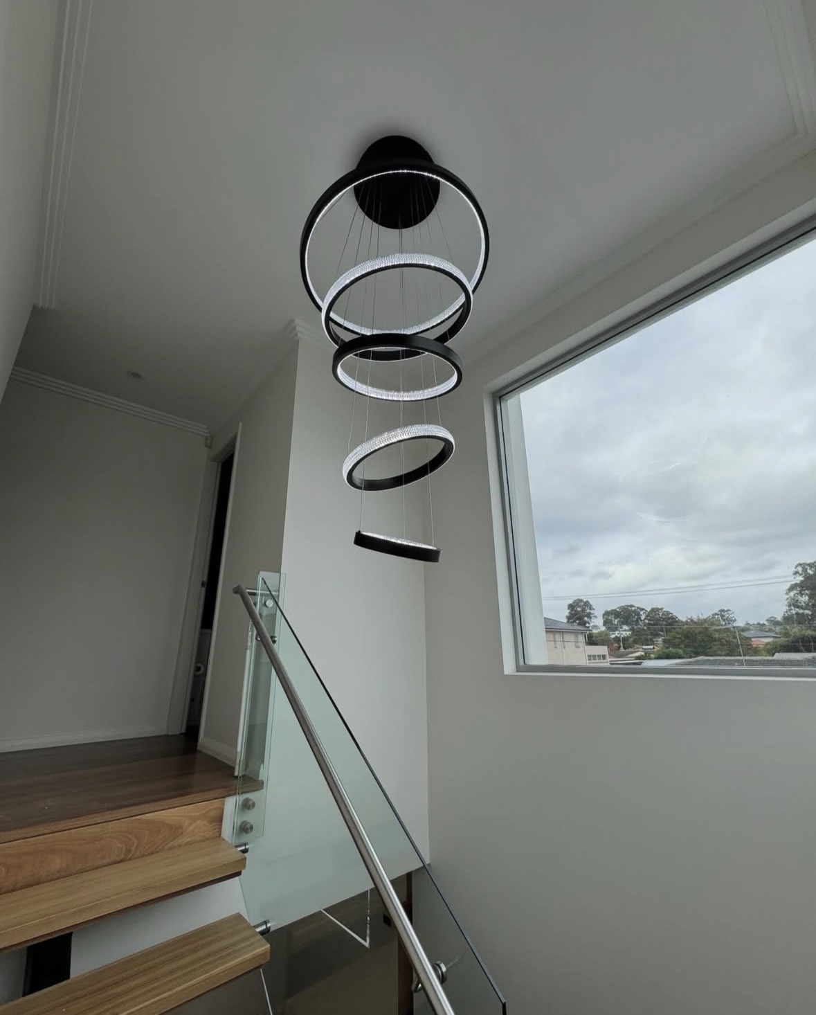 Modern ring pendant lighting above stairwell