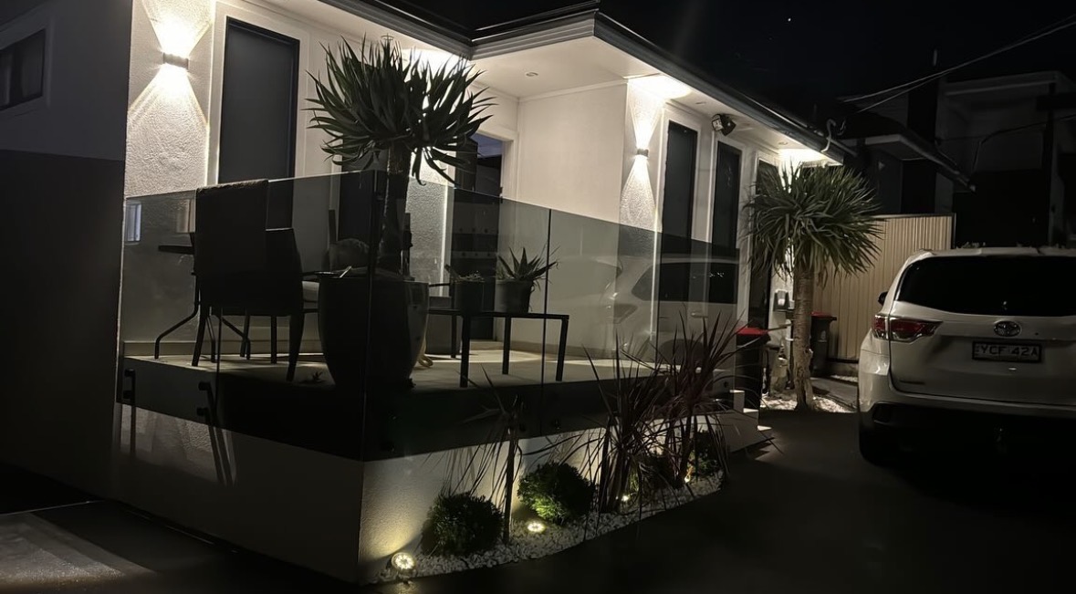 Exterior residential architectural and garden lighting at night
