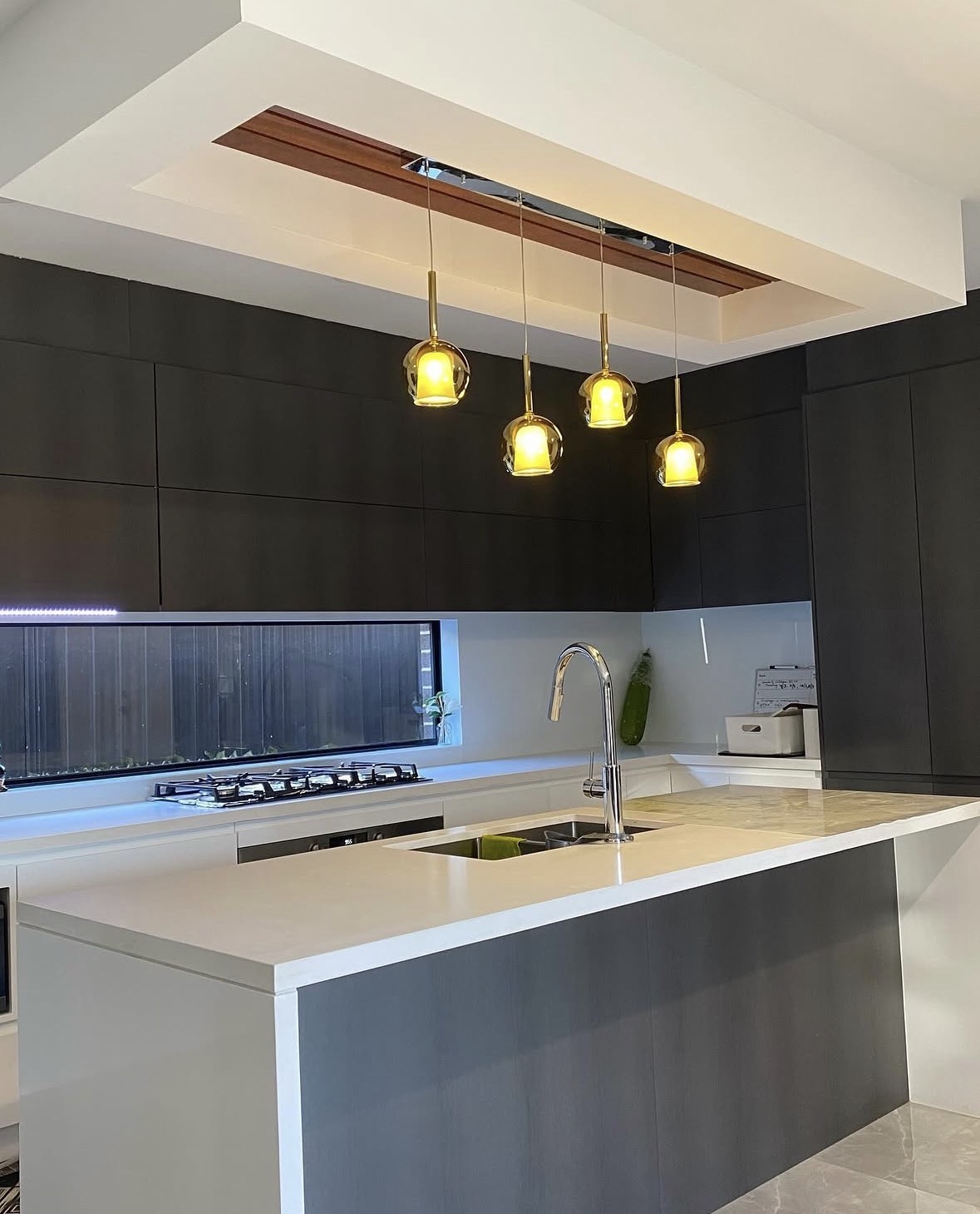 Close view of pendant lights over kitchen island
